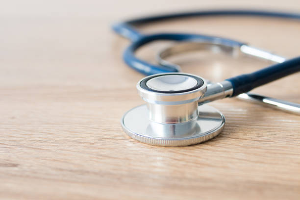 istock medical stethoscope on wood background 1189580258
