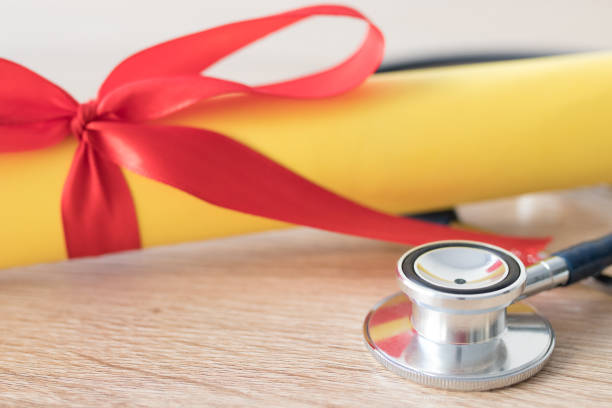 istock university diploma with stethoscope, concept of science and training 1189580328