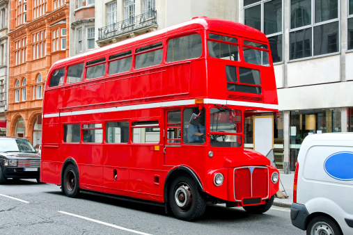 Red double deck bus at heritage route in London.