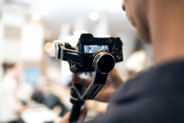 istock Adult professional videographer shooting using new steadycam 1189581142