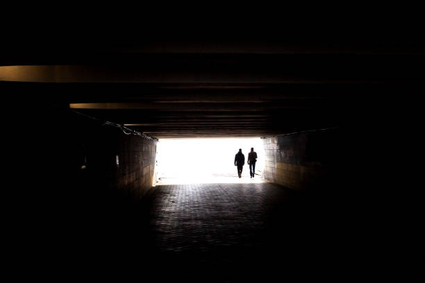 istock People come out of a dark tunnel 1189581237