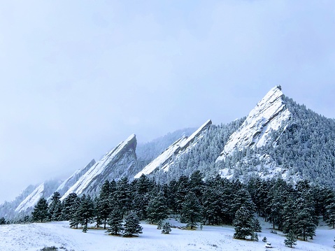 The famous Flatirons bear Chautauqua Park in Boulder, covered in snow