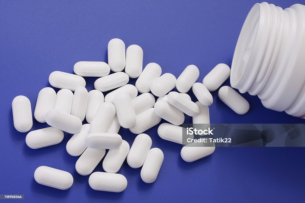 Spilled tablets and medicine bottle.  Antibiotic Stock Photo