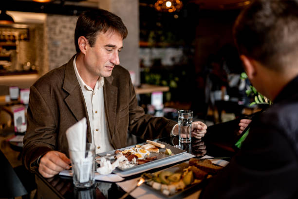istock Two business people working in restaurant 1189584943