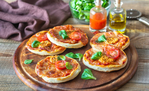 istock Mini pizzas on the wooden board 1189585669