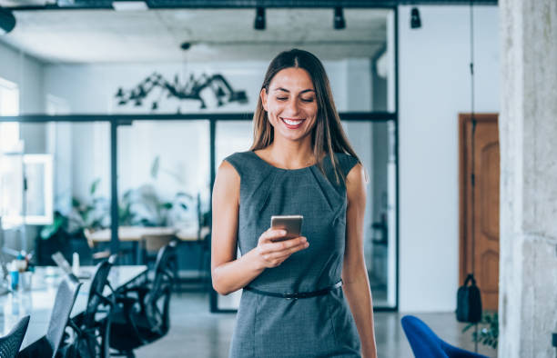 Happy businesswoman using phone
