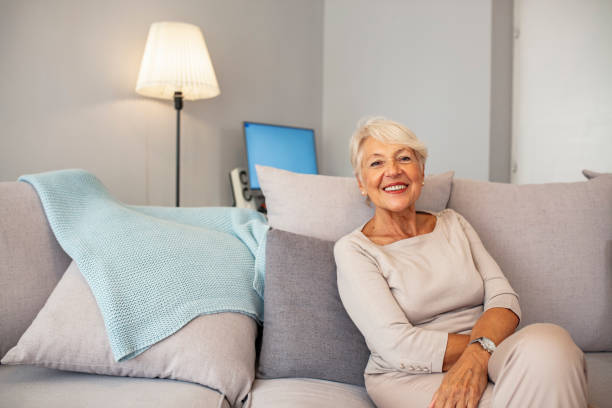 Smiling middle aged mature grey haired woman looking at camera