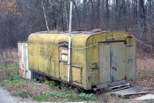 istock one old green iron trailer stands in dry grass and vegetation 1189610159