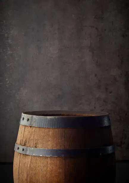 old wooden barrel on grey background, copy space
