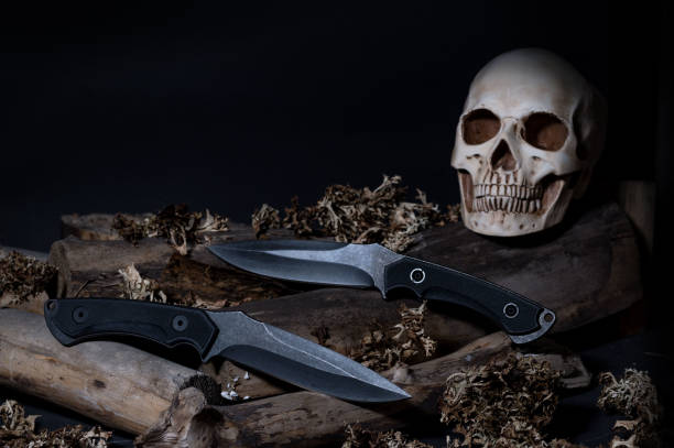 istock Two large knives. Human skull. Dangerous knives. 1189611140