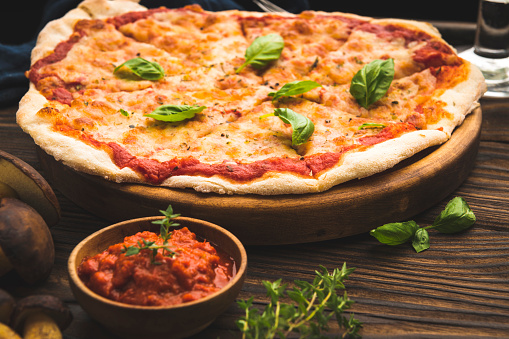 Delicious tomato sauce cheese covered hot and tasty vegetarian pizza pie