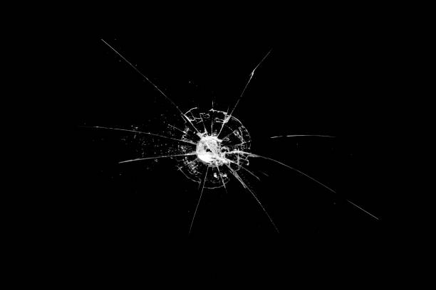 istock hole in the glass with cracks isolated on a black background 1189616501