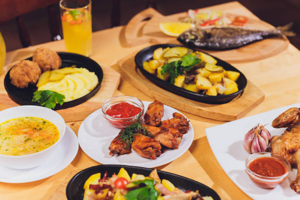 istock Dinner table with meat grill, roast new potatoes, vegetables, salads, sauces, snacks and lemonade, top view. 1189616890