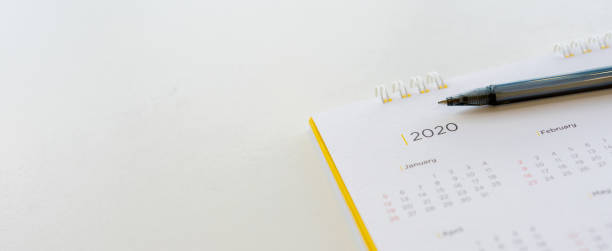 istock close up side view on  white calendar schedule background with pen to make appointment meeting or manage timetable each day for planning work in new year 2020 resolution concept 1189616928