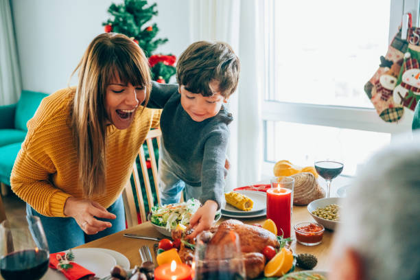 istock Happy mother and her son having fun while holding roasted turkey leg 1189618234