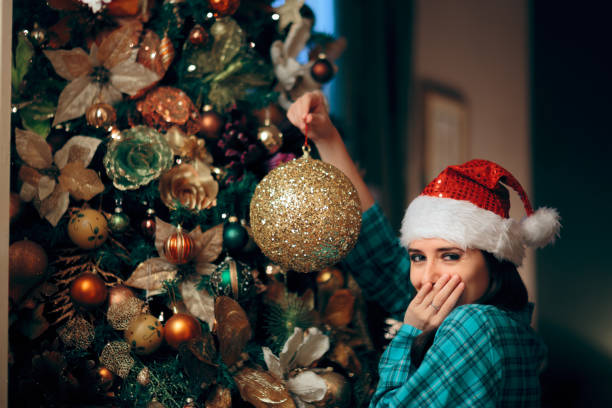 Shy giggling woman putting the last decoration waiting for Santa