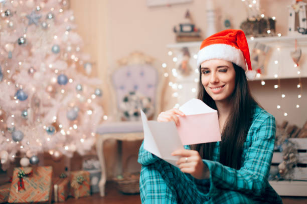 istock Woman Reading Love Letter under the Christmas Tree 1189624265