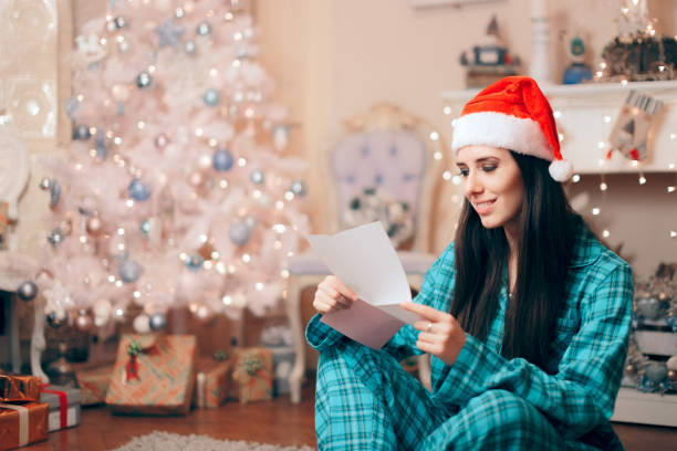 Woman Reading Love Letter under the Christmas Tree