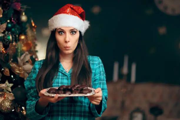 Photo of Woman Holding a Tray of Cookies Waiting for Santa Claus