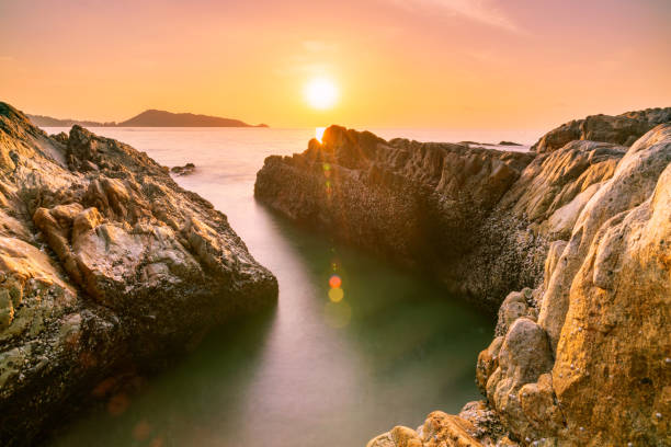 istock Long exposure image of Dramatic sky seascape with rock in sunset scenery background 1189631249