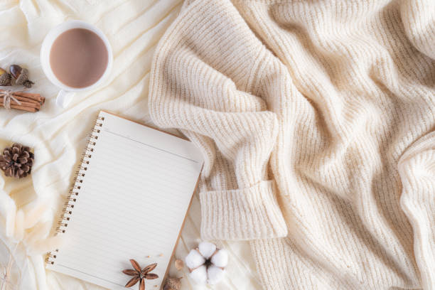 istock Autumn or winter composition. Gift box Coffee cup, notebook, anise stars, beige sweater on cream color knitted blanket background. Flat lay top view copy space. 1189636666
