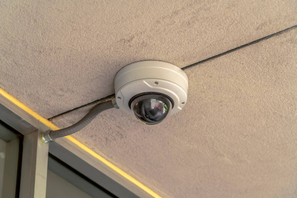 istock Focus on a cctv security camera at the outdoor ceiling of a building 1189642696