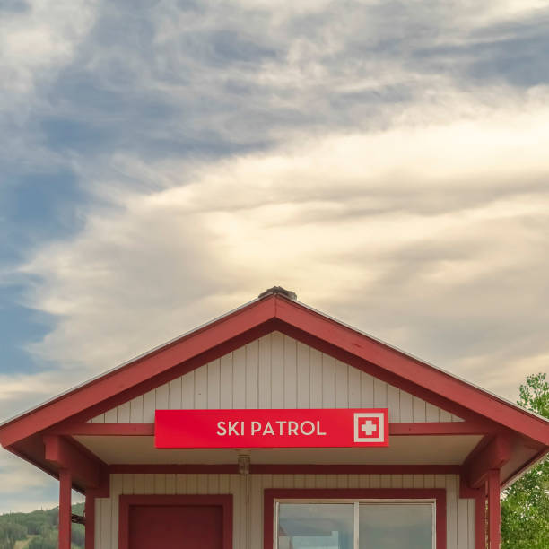 Square frame Ski Patrol wooden building with stairs and porch in Park City Utah in summer Square frame Ski Patrol wooden building with stairs and porch in Park City Utah in summer. The ski resort is blanketed with greenery during off season. ski patrol photos stock pictures, royalty-free photos & images