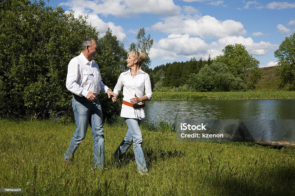 Senior Couple running on a meadow  Active Lifestyle Stock Photo