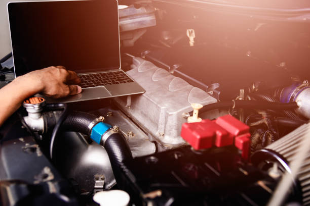istock Professional car repair or maintenance mechanic engine working service with laptop computer 1189648031