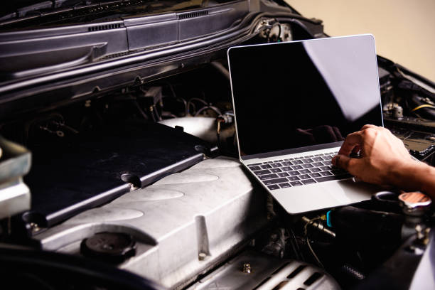 istock Professional car repair or maintenance mechanic engine working service with laptop computer 1189648060