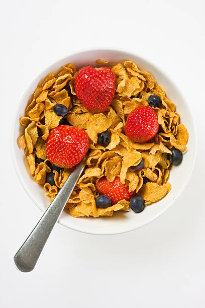 istock White bowl with cornflakes, berries and a spoon 118964838