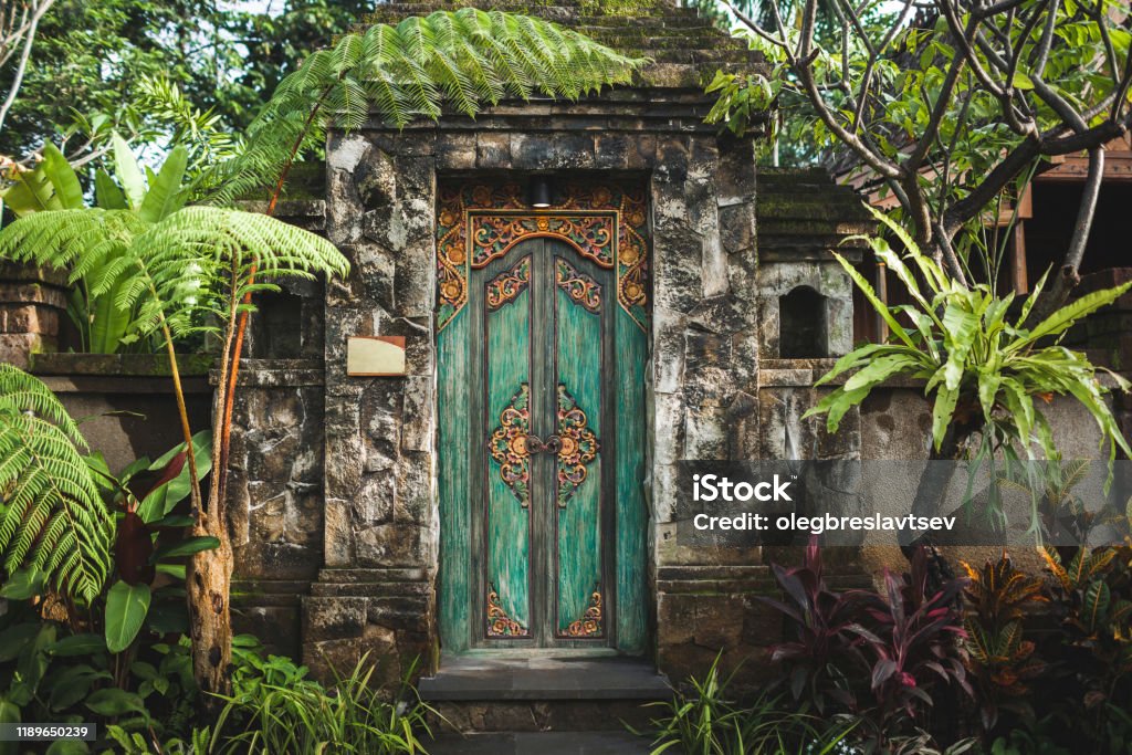 Traditional balinese handmade carved wooden door Traditional balinese handmade carved wooden door. Bali style furniture with ornament details Bali Stock Photo
