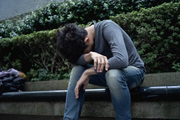 istock An asian man sitting outdoor with disappointment. 1189682489