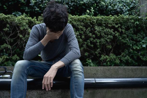 istock An asian man sitting outdoor with disappointment. 1189682502