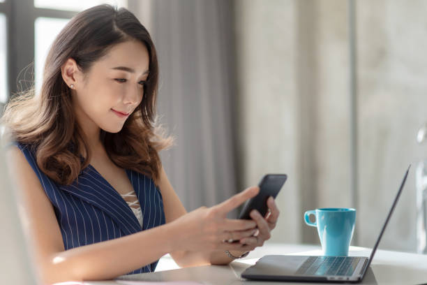 Asian Businesswoman using smartphone.