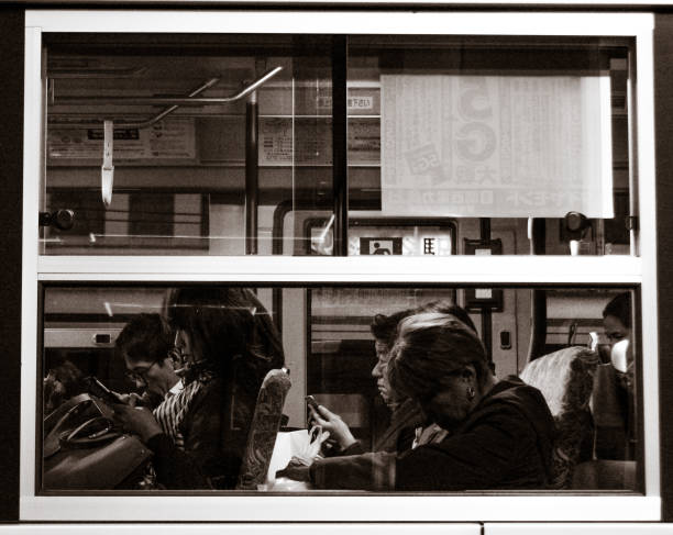 Photo taken in Tokyo, Japan in November 2019. Snapshots of everyday life in Tokyo, Japan with two women commuting after a day of work. editorial use only. black and white