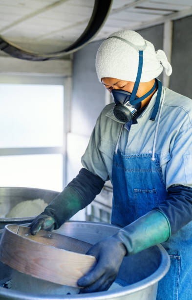 istock Man mixing chemicals as part of the firework manufacturing process 1189684320