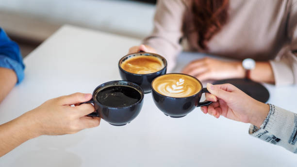 istock people enjoyed drinking and clinking coffee cups together on the table in cafe 1189687477