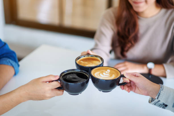 istock people enjoyed drinking and clinking coffee cups together on the table in cafe 1189687482