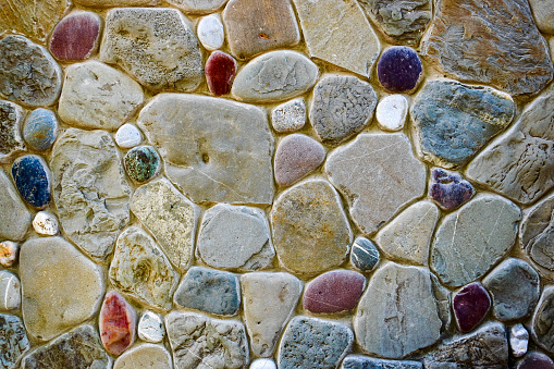 Wall of multi-colored stones. Mosaic. Texture. Background