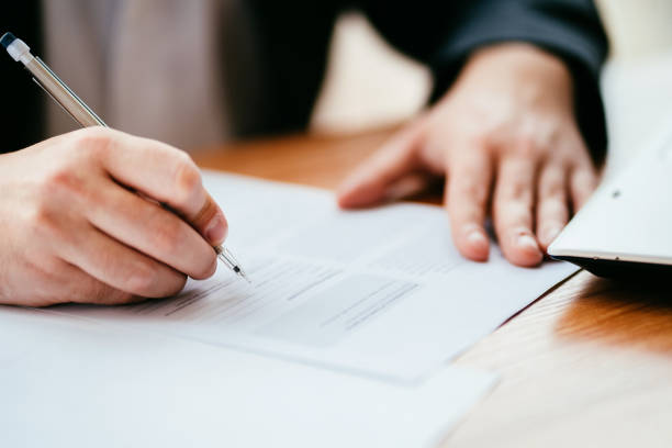 istock Businessman filling document, signing contract 1189692585