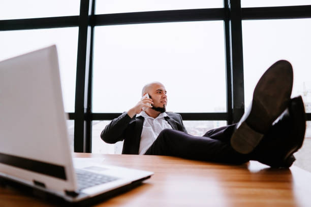 istock Businessman talking on phone satisfied and relaxed 1189692655