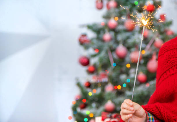 istock Christmas, girl with sparklers in hands. Selective focus. 1189694045