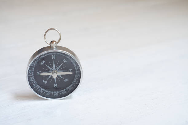 istock Compass on white wooden table background, journey planning concept, copy space 1189696105