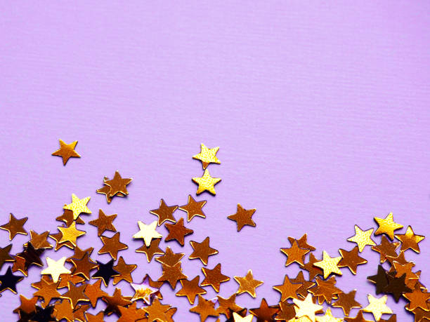 istock Golden stars glitter on violet background 1189696587