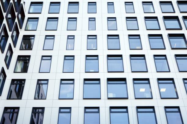 istock Modern European building. White building with many windows against the blue sky. 1189697065