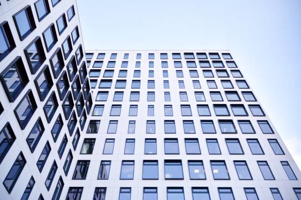 istock Modern European building. White building with many windows against the blue sky. 1189697192