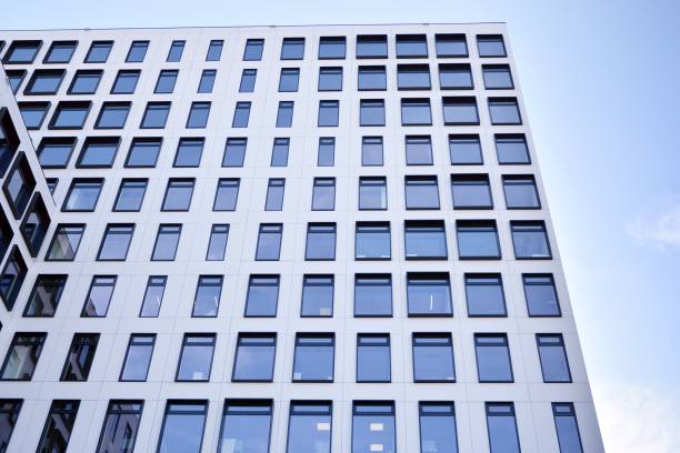istock Modern European building. White building with many windows against the blue sky. 1189697315