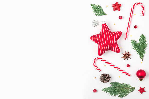 istock Christmas background. Fir tree branches, red decorations, candy, pine cones on white background. top view 1189699163