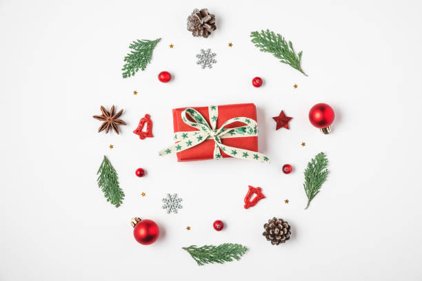 istock Christmas composition. Christmas wreath made of fir tree branches, decorations, berries with gift box on white background 1189699253